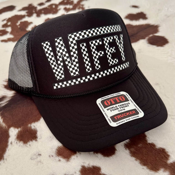 Black trucker cap with 'WIFEY' text on a cowhide background