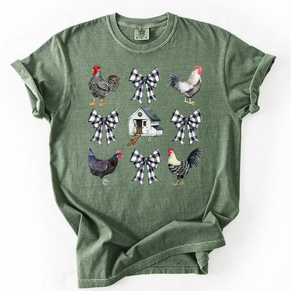Green t-shirt with rooster and checkered bow designs on a white background