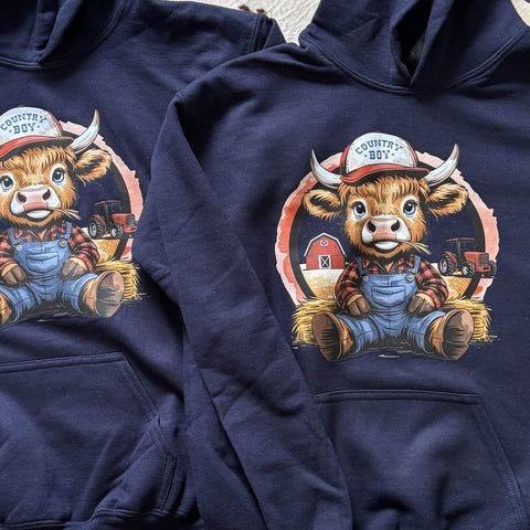 Navy blue hoodie with a cartoon bull wearing overalls and a 'Country Boy' hat on a white background.