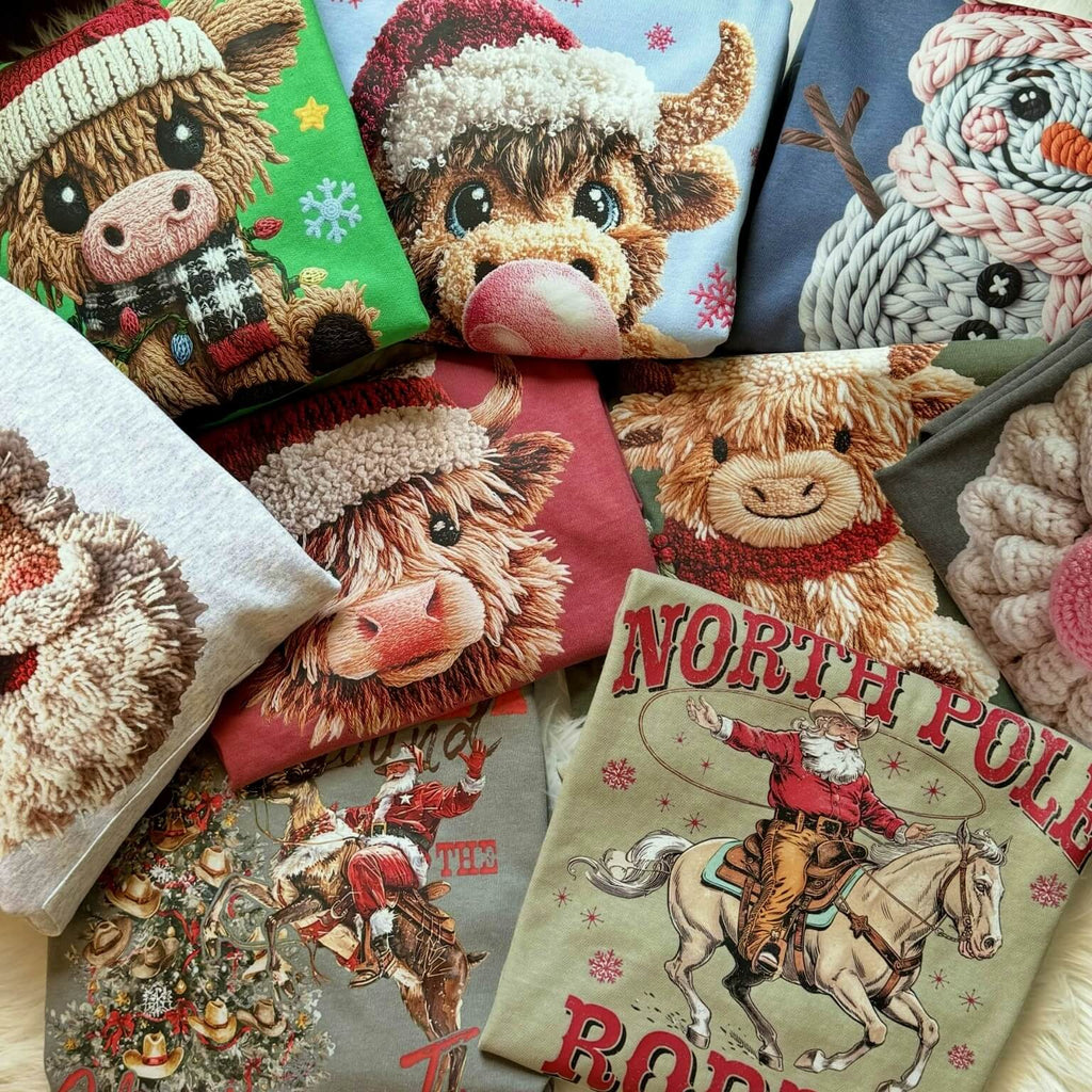 Collection of decorative rustic graphic tees & pullovers with festive Christmas designs including animals and text.