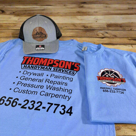 Blue t-shirt and cap with Company Logo  business branding on a wooden surface