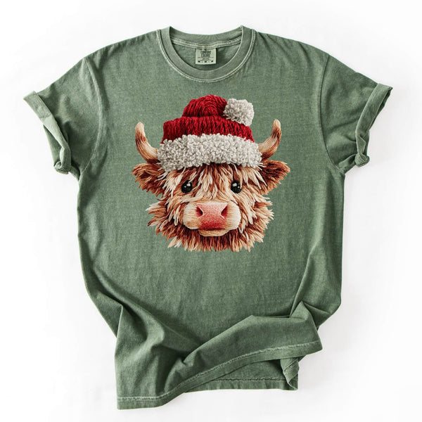 Green t-shirt with a highland cow wearing a Santa hat design on a white background