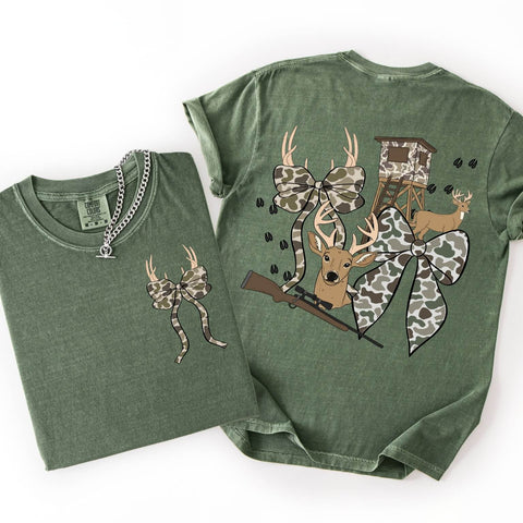 Green coquette camo t-shirt with hunting-themed design on a white background