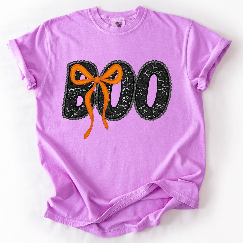 Purple Halloween t-shirt with 'BOO' and a bow design on a white background
