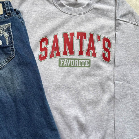 Gray sweatshirt with 'Santa's Favorite' text on a blue denim background