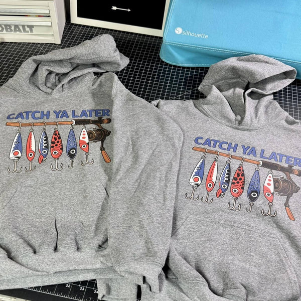 Youth gray hoodies with fishing lure and reel graphic reading Catch Ya Later
