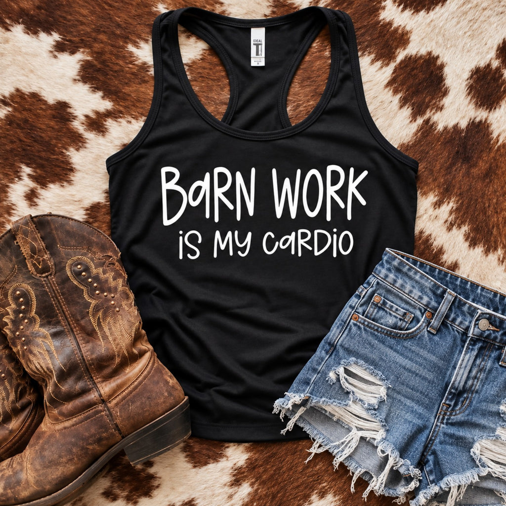 Black Barn Work Is My Cardio women's racerback tank top with white lettering, styled with denim shorts and cowboy boots on cowhide.