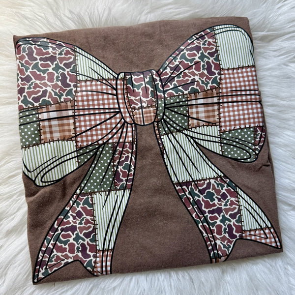 Camo patchwork bow graphic tee on brown shirt featuring rustic camouflage and gingham bow design