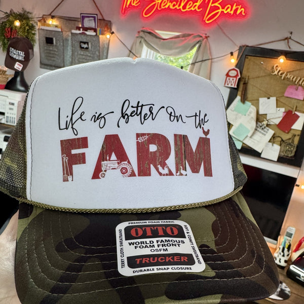 Life is Better on the Farm camo trucker hat with white foam front, red farm graphic and rope detail