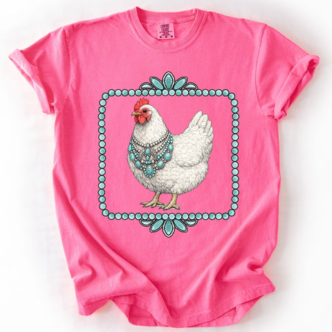 Pink t-shirt with a chicken wearing turquoise jewelry design on a white background
