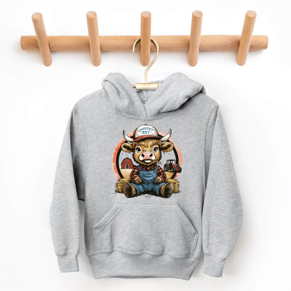 Gray hoodie with a cartoon bull design hanging on a wooden rack.