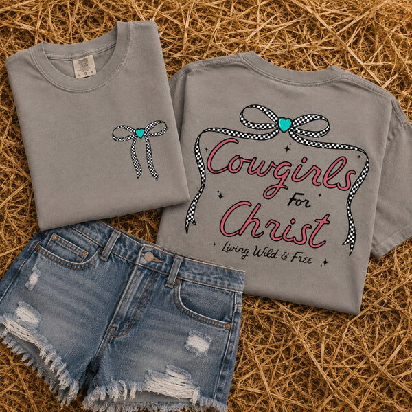 Cowgirls for Christ Comfort Colors gray graphic tee with front bow and back Christian cowgirl design styled with distressed denim shorts