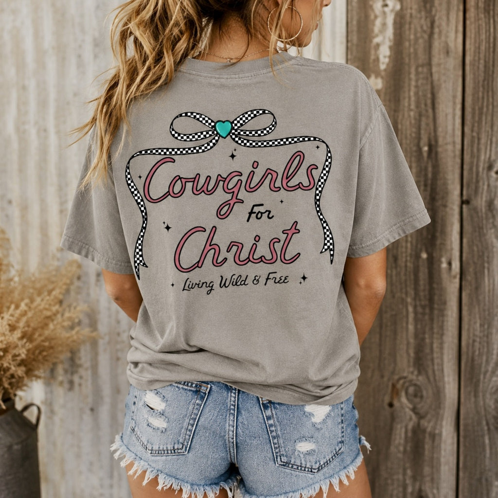 Woman wearing gray Cowgirls for Christ Comfort Colors graphic tee with checkered bow and Christian cowgirl back design