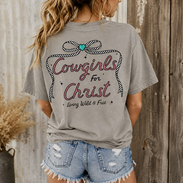 Woman wearing gray Cowgirls for Christ Comfort Colors graphic tee with checkered bow and Christian cowgirl back design
