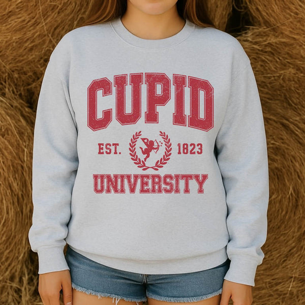 Cupid University Valentine’s Day sweatshirt with vintage red collegiate lettering on ash gray crewneck