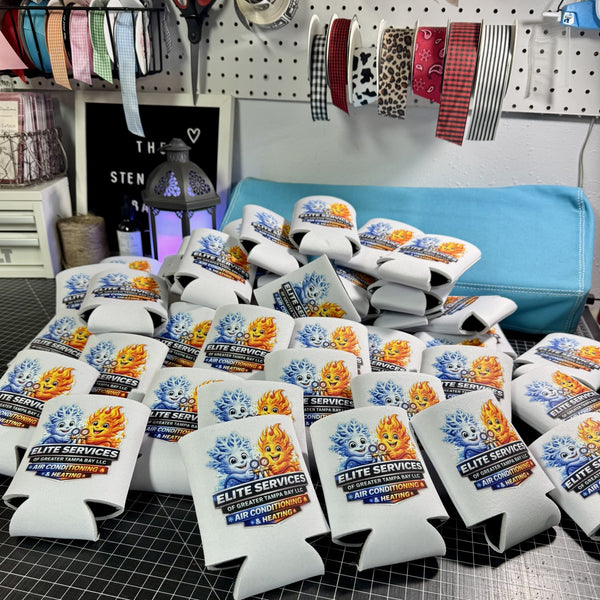 Multiple branded can coolers on a table with custom business logo