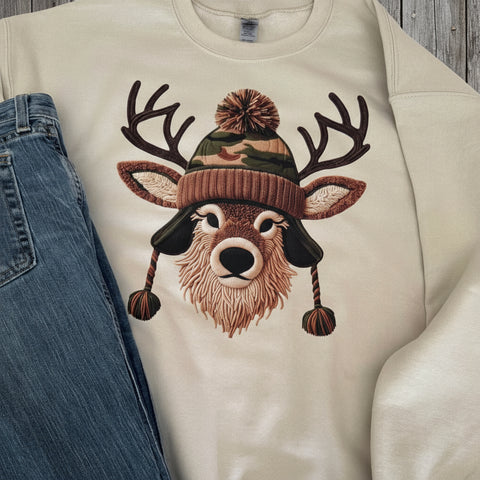 Beige sweatshirt with a deer wearing a camo hat design on a white background