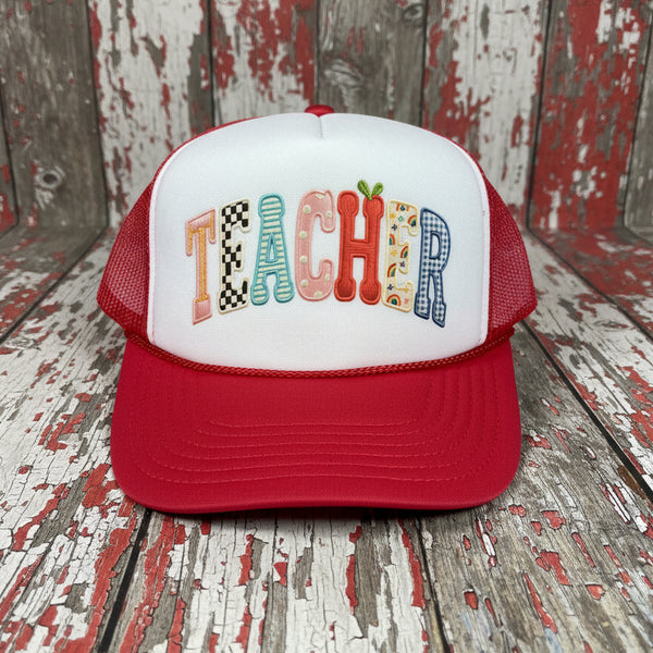 Red and white foam mesh trucker hat with colorful faux applique “TEACHER” lettering on the front panel — cute teacher gift and back to school accessory