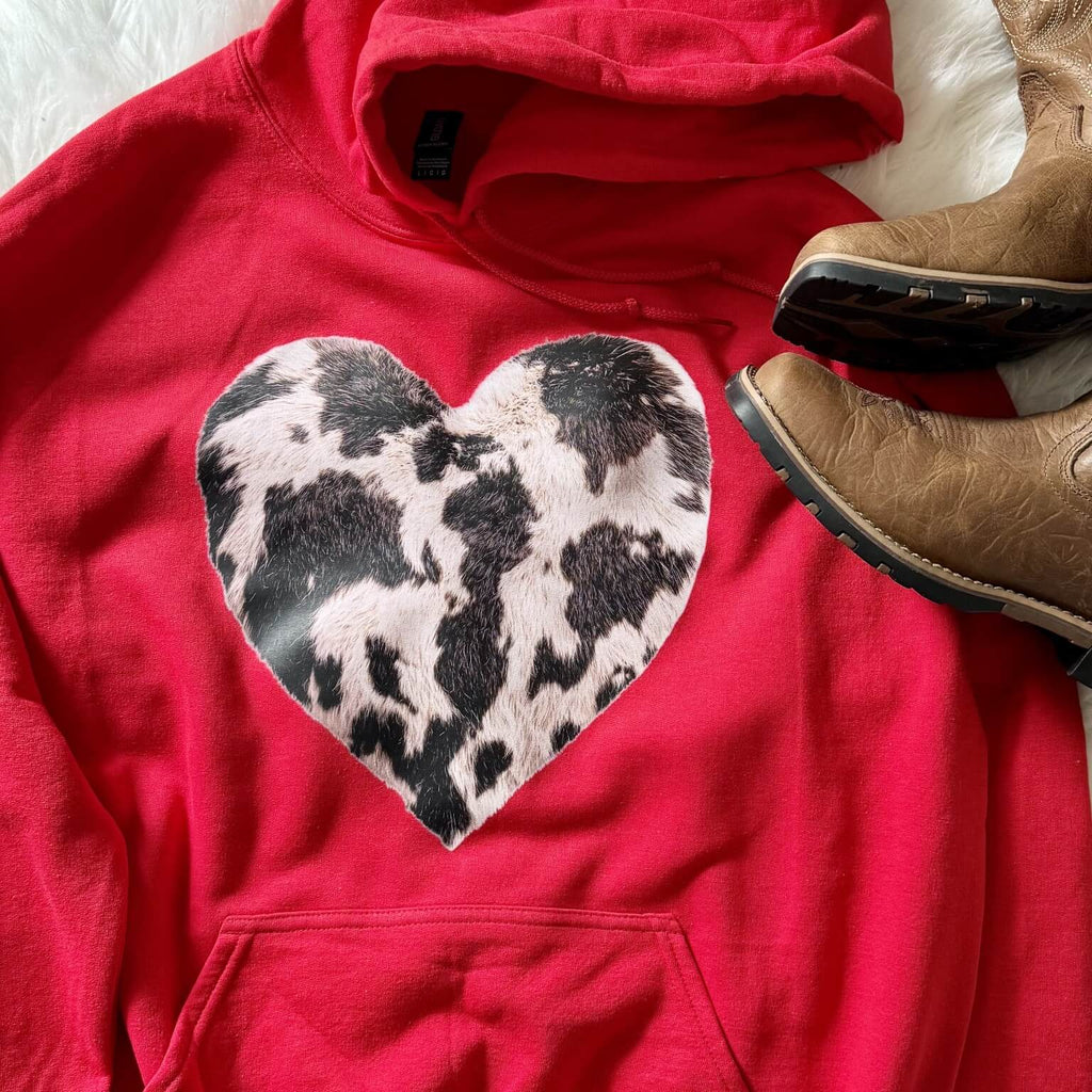 Red western hoodie with faux cowhide heart graphic styled with cowboy boots