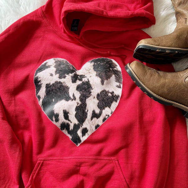 Red western hoodie with faux cowhide heart graphic styled with cowboy boots