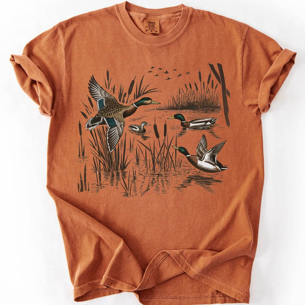 Orange t-shirt with mallard ducks design on a white background