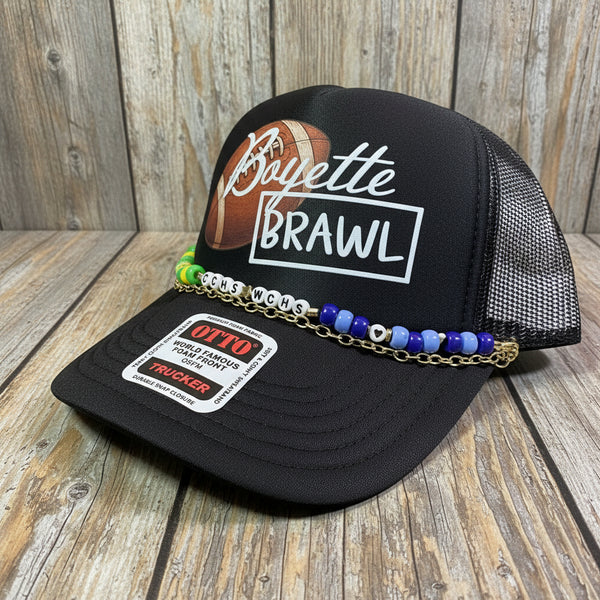 Black cap with 'Boyette Brawl' design and colorful beaded chain on a grid background