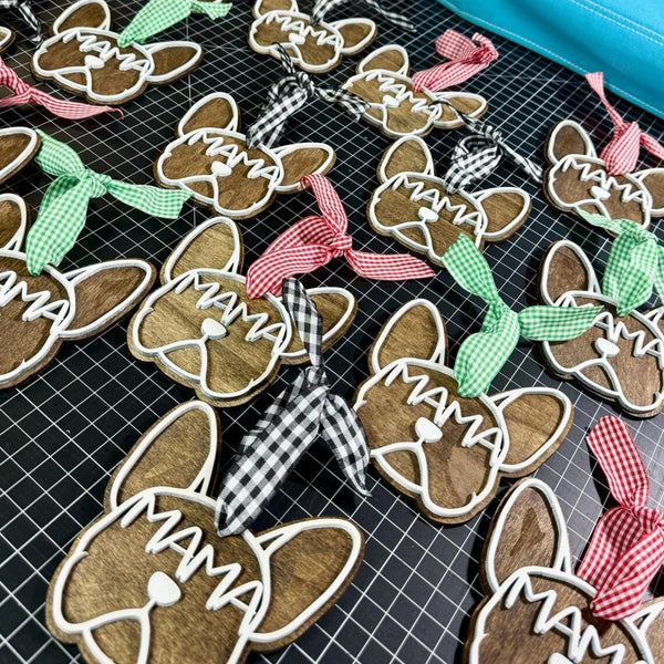 Handmade French Bulldog mama wooden ornament with rustic stained wood, layered white painted details, and gingham ribbon, displayed as personalized dog mom gift tags on a craft table.
