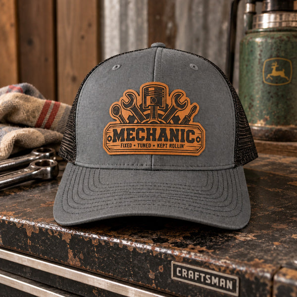 Mechanic leather patch Richardson 112 trucker hat displayed in an automotive garage