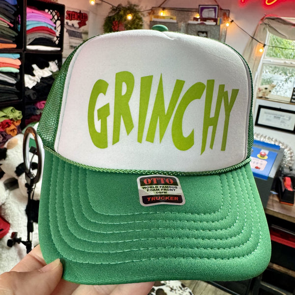 Grinch inspired Christmas trucker hat with bright green lettering on white and green foam mesh cap