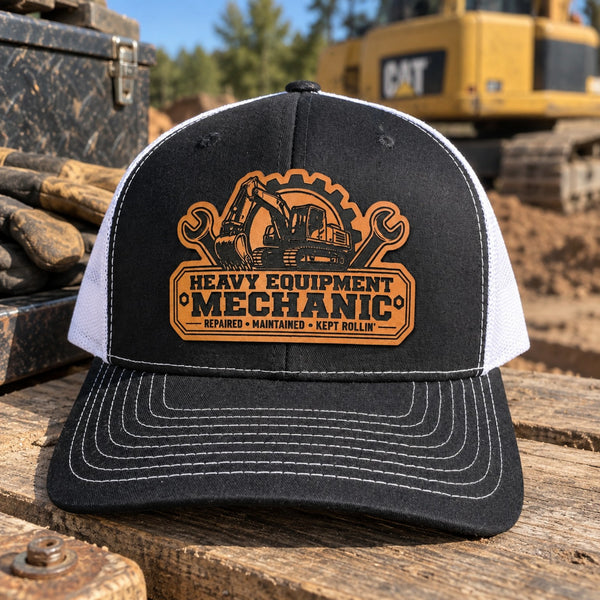 Black and white Heavy Equipment Mechanic trucker hat with engraved leather patch and excavator in background