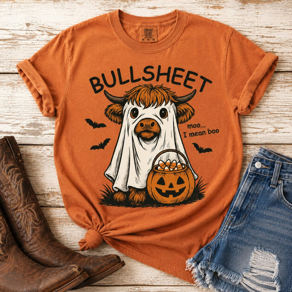 Yam Comfort Colors Halloween graphic tee featuring a Highland cow dressed as a ghost with Bullsheet saying, pumpkin candy bucket and bats, styled with denim shorts and cowboy boots.
