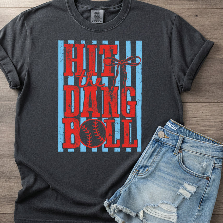 Gray t-shirt with red and blue baseball graphic design on a wooden background