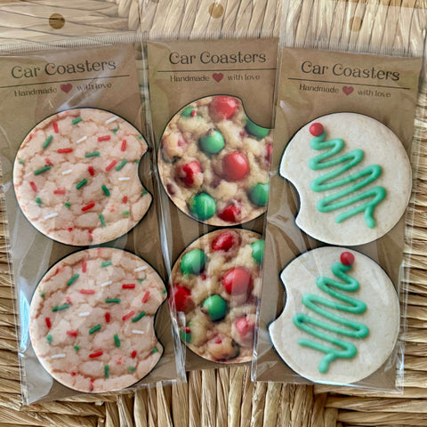 Packaged car coasters with festive  holiday cookie designs on a woven surface