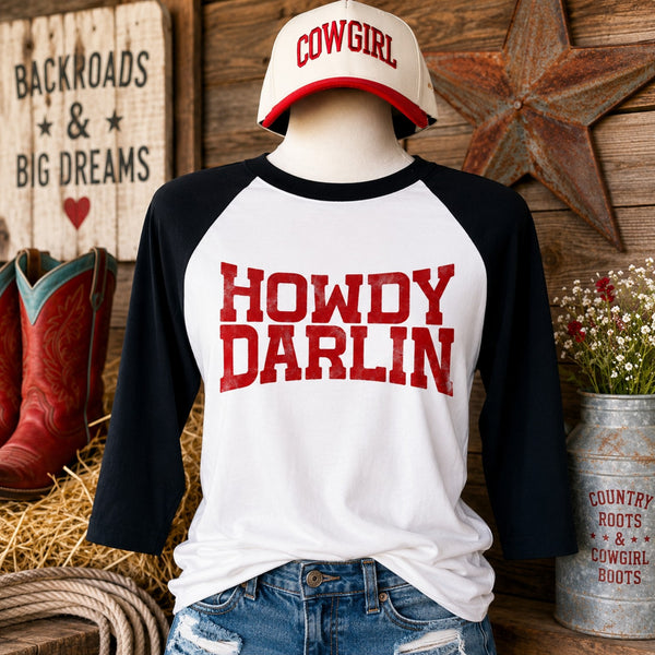 Howdy Darlin raglan graphic tee with black 3/4 sleeves and distressed red western lettering.