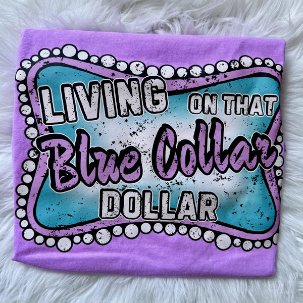 Living on That Blue Collar Dollar graphic tee on neon violet shirt with western marquee sign design