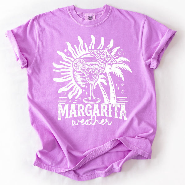 Margarita Weather graphic tee on Neon Violet Comfort Colors shirt with tropical margarita drink, palm tree, and summer beach design in white print