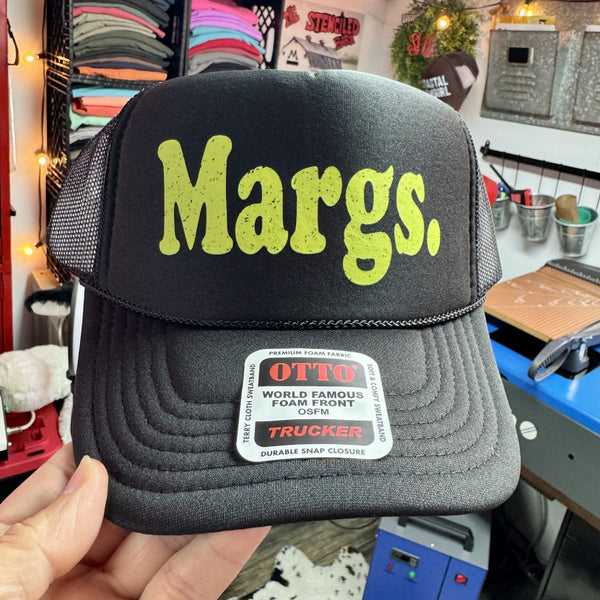 Black foam trucker hat with Margs graphic in lime green lettering for margarita lovers and beachside fun.