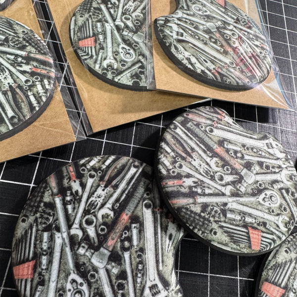 Close up mechanic car coasters with detailed wrenches ratchets sockets and automotive tool design