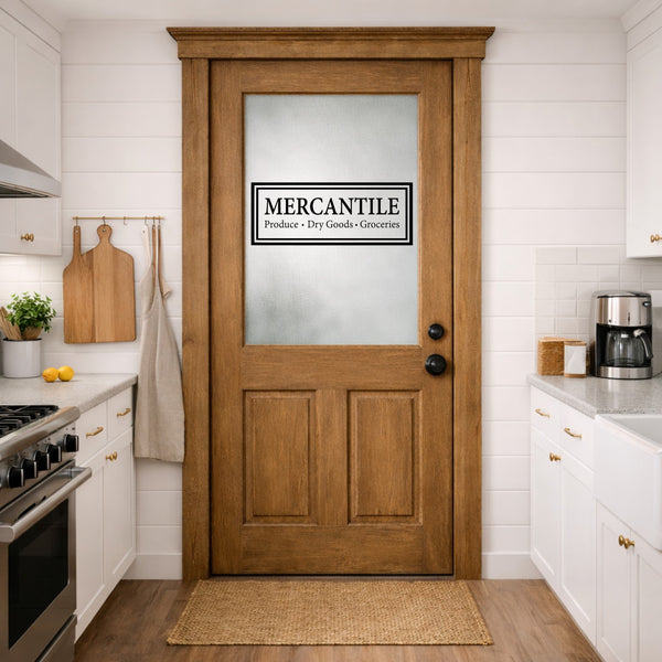 Wooden door with 'Mercantile' door decal sign in a kitchen setting