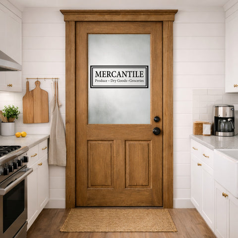 Wooden door with 'Mercantile' door decal sign in a kitchen setting