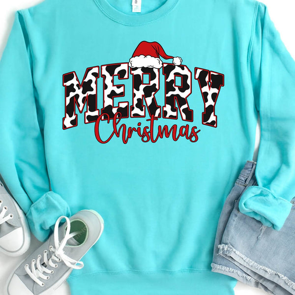 Turquoise sweatshirt with 'Merry Christmas' cow print text and Santa hat graphic, paired with gray sneakers and jeans.