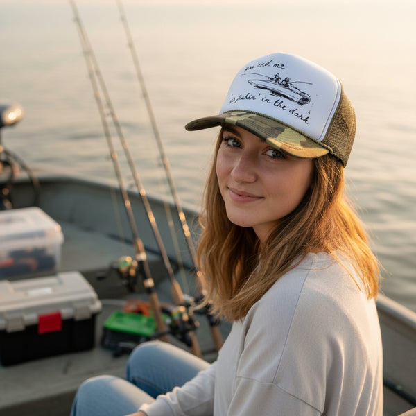 Woman wearing a cap on a boat with fishing equipment