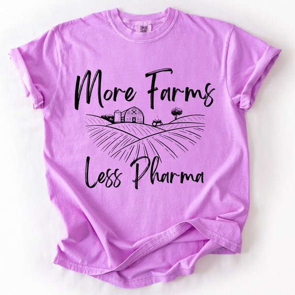 Purple t-shirt with 'More Farms Less Pharma' text and graphic on a white background