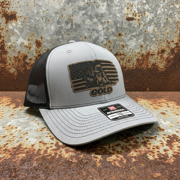 Grey Richardson 112 trucker hat with black mesh and laser-engraved welder USA flag patch on front