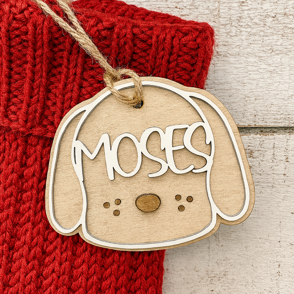 Wooden dog-shaped tag with personalized name on a red fabric Christmas stocking background