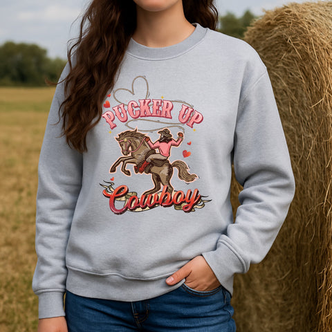 Person wearing a gray Valentine's Day sweatshirt with a cowboy graphic and text in an outdoor setting.