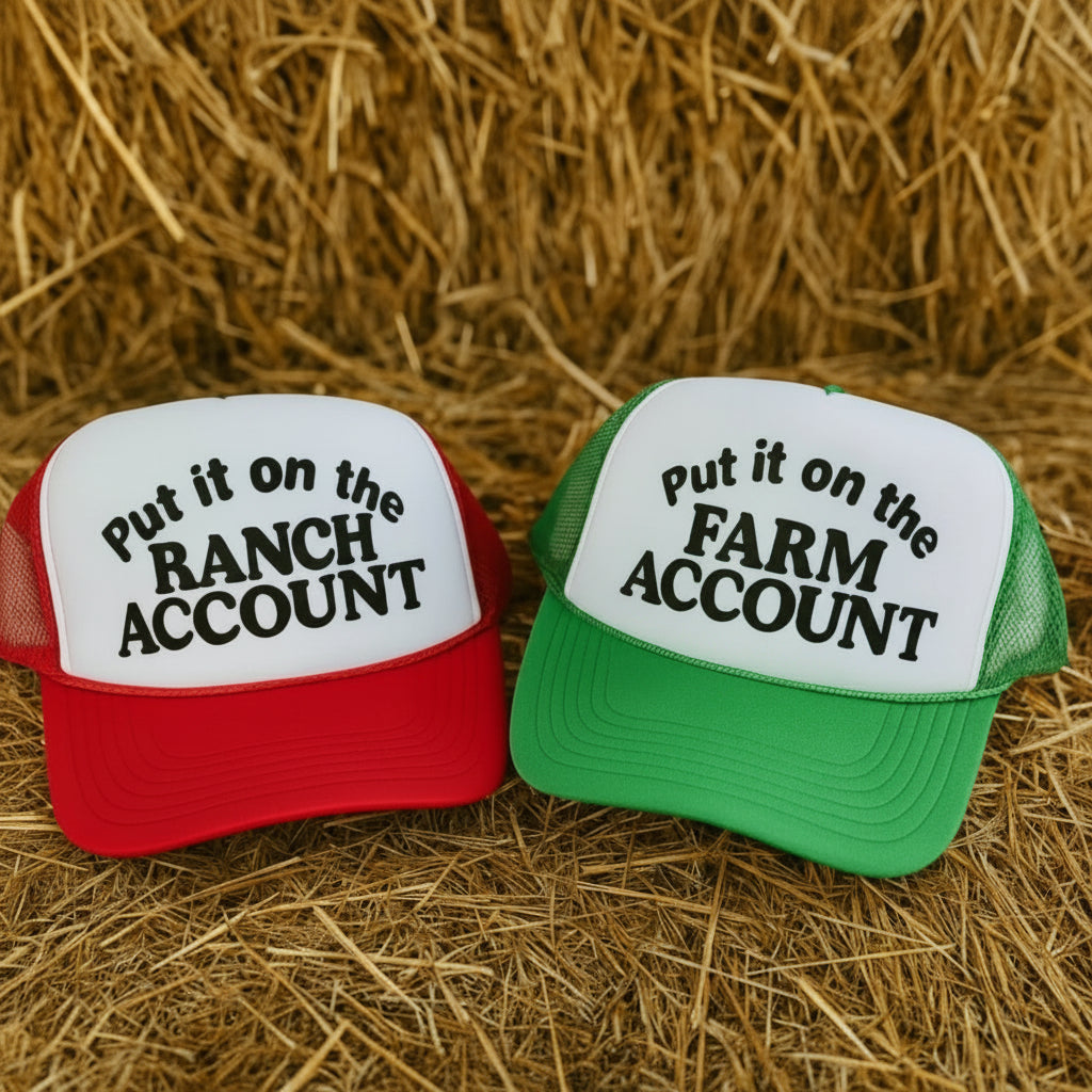 Red and green “Put it on the Ranch Account” and “Put it on the Farm Account” funny trucker hats on a hay bale – The Stenciled Barn