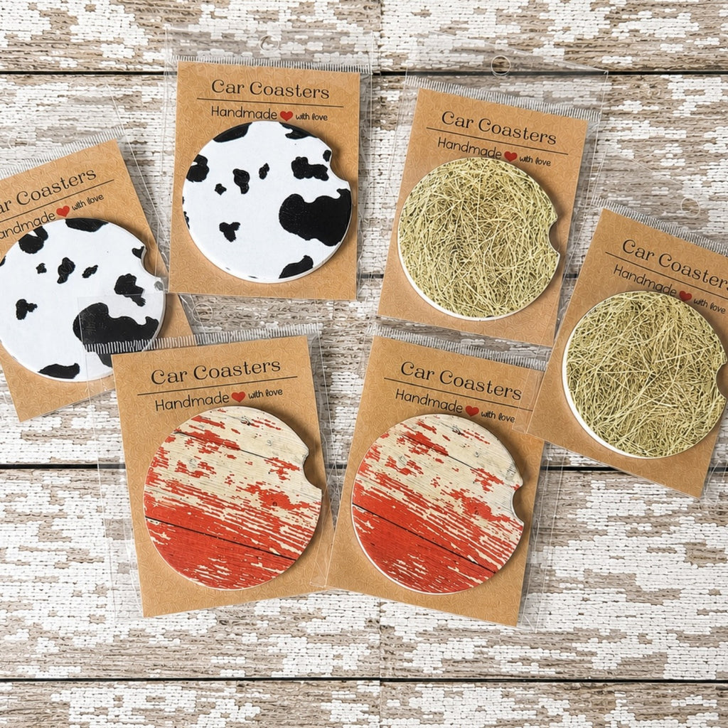 Rustic farmhouse car coasters featuring faux cow print, weathered barn wood and hay bale designs available in ceramic or neoprene.