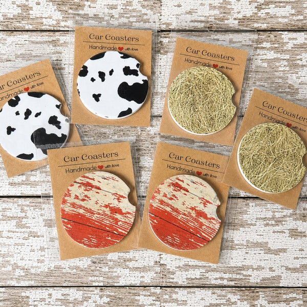 Rustic farmhouse car coasters featuring faux cow print, weathered barn wood and hay bale designs available in ceramic or neoprene.