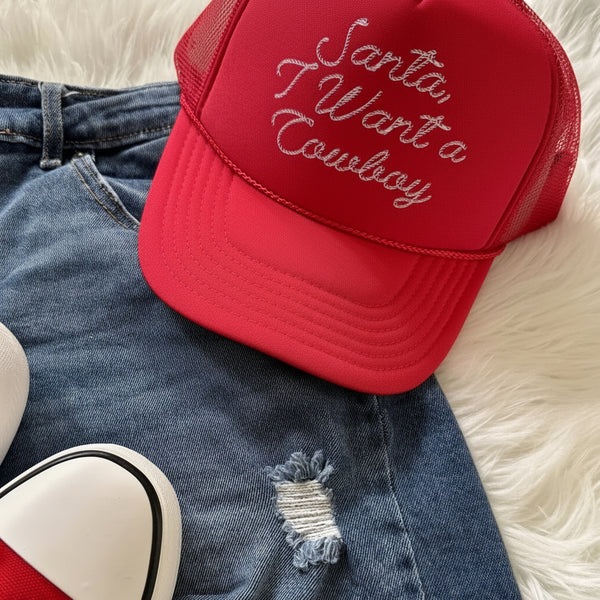 Red “Santa, I Want a Cowboy” Christmas cowgirl trucker hat styled with denim shorts and sneakers – western holiday accessories